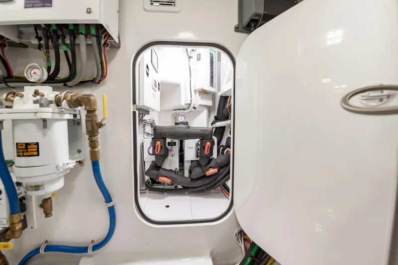 Slide: The Image of Engine room of 2024 Viking 72 Convertible yacht, showcasing mechanical components and wiring. - 111