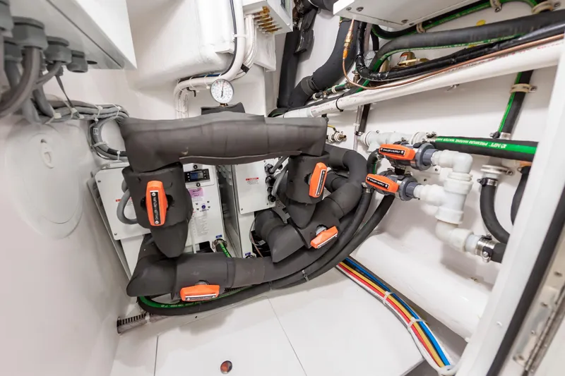 Slide: The Image of Engine room of 2024 Viking 72 Convertible yacht with complex piping and wiring systems. - 115