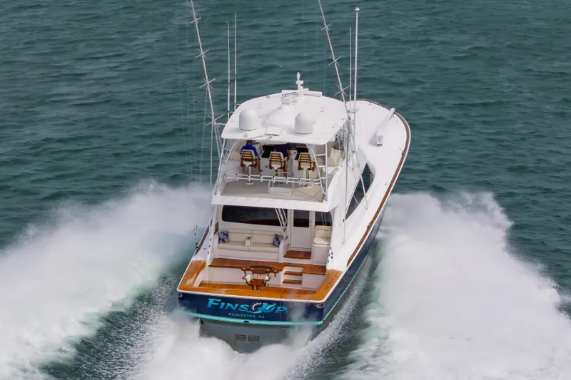 Slide: The Image of 2024 Viking 72 Convertible yacht cruising swiftly on open water. - 17