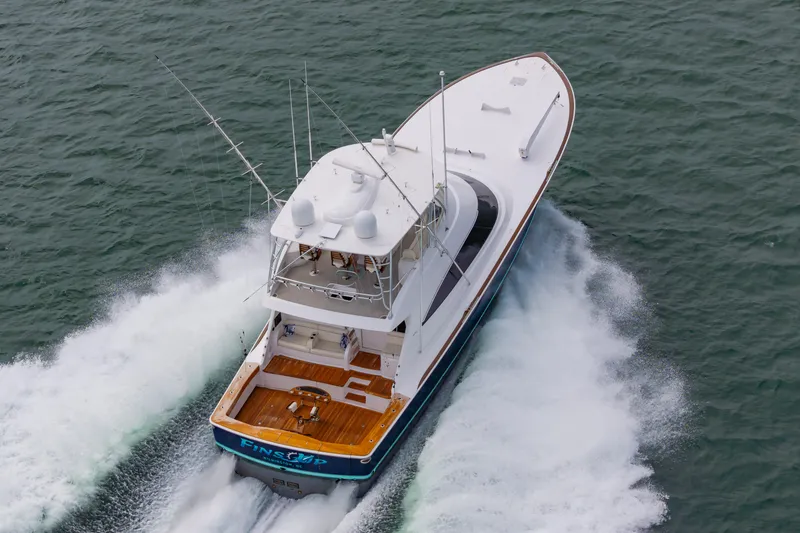 Slide: The Image of 2024 Viking 72 Convertible yacht cruising swiftly on open water. - 19