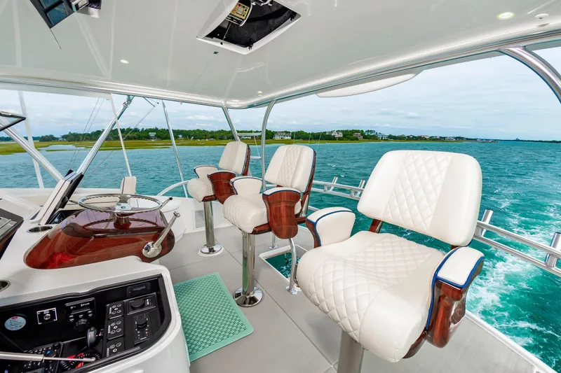 Slide: The Image of Luxurious helm seating on 2024 Viking 72 Convertible yacht with ocean view. - 29