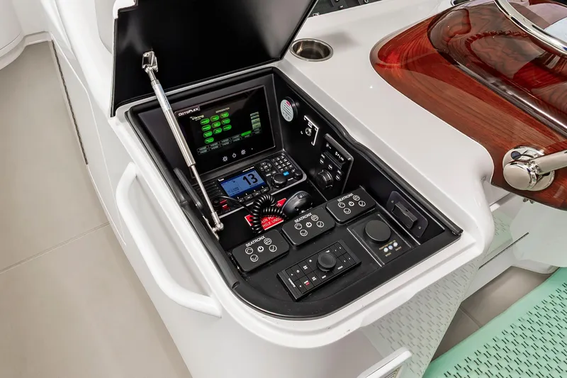 Slide: The Image of 2024 Viking 72 Convertible yacht control panel with advanced navigation and communication systems. - 30