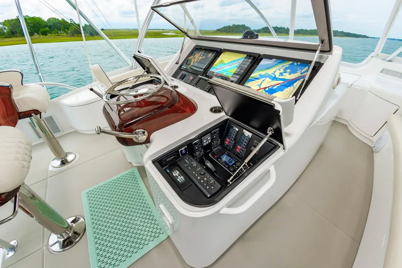 Slide: The Image of 2024 Viking 72 Convertible yacht helm with advanced navigation displays and controls. - 31