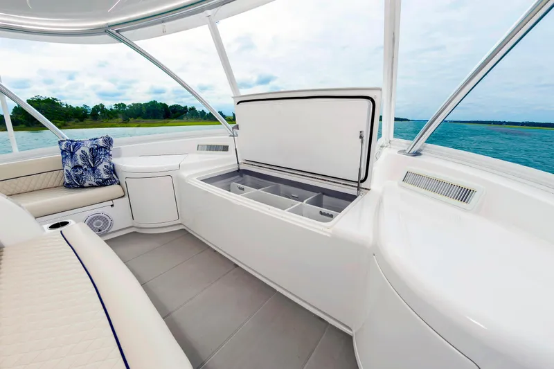 Slide: The Image of Luxurious interior of 2024 Viking 72 Convertible yacht with seating and storage. - 34