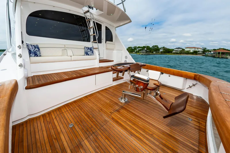 Slide: The Image of Luxurious 2024 Viking 72 Convertible yacht deck with wooden flooring and seating. - 36