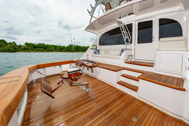 Slide: The Image of Luxurious 2024 Viking 72 Convertible yacht deck with wooden flooring and seating area. - 37