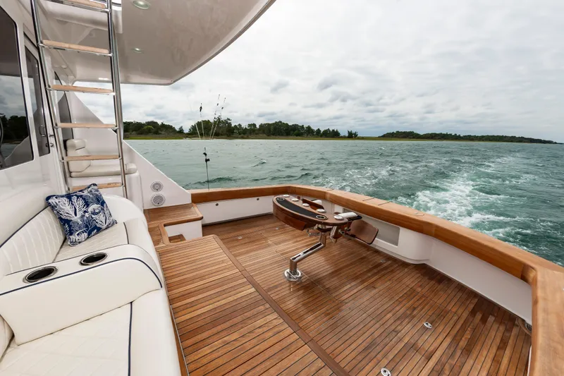 Slide: The Image of Luxurious 2024 Viking 72 Convertible yacht with elegant teak deck and scenic ocean view. - 38