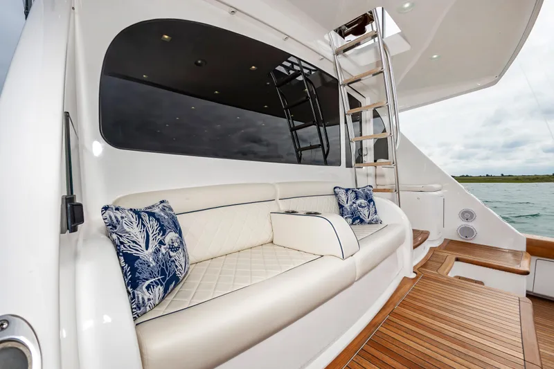 Slide: The Image of Luxurious seating area on 2024 Viking 72 Convertible yacht with elegant cushions and wooden flooring. - 39