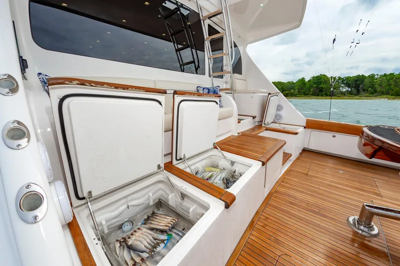 Slide: The Image of 2024 Viking 72 Convertible yacht deck with open fish storage compartments. - 40
