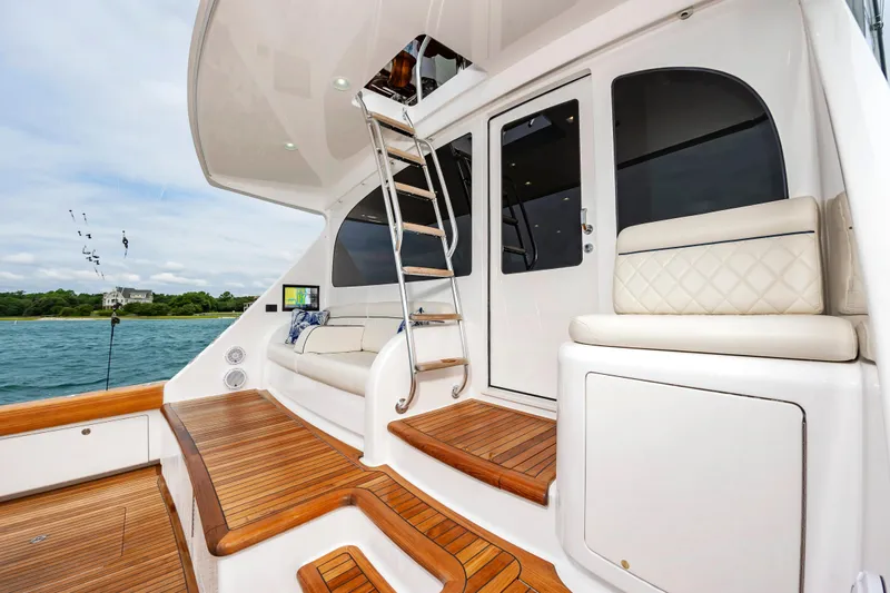 Slide: The Image of Luxurious 2024 Viking 72 Convertible yacht deck with elegant seating and wooden flooring. - 41