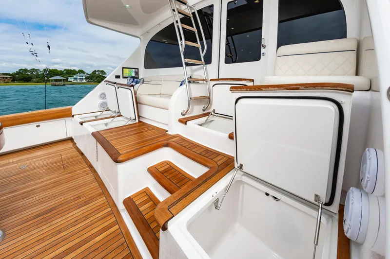 Slide: The Image of Luxurious 2024 Viking 72 Convertible yacht interior with teak flooring and plush seating. - 42