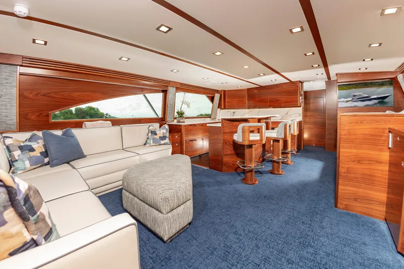 Slide: The Image of Luxurious interior of 2024 Viking 72 Convertible yacht with elegant seating and wooden finishes. - 44