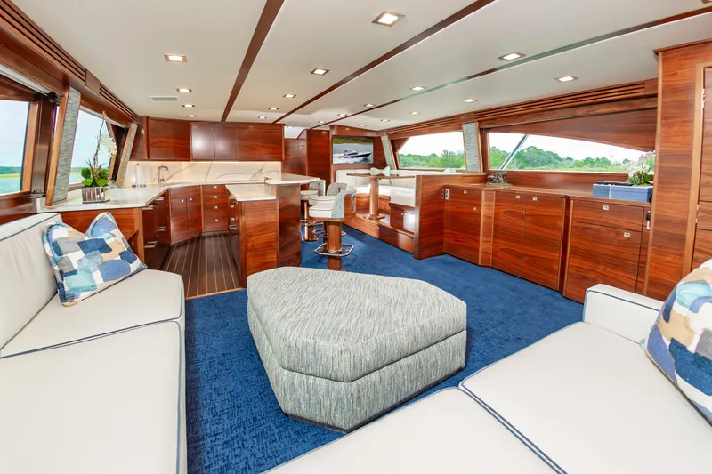 Slide: The Image of Luxurious interior of 2024 Viking 72 Convertible yacht with elegant wood finishes and plush seating. - 46