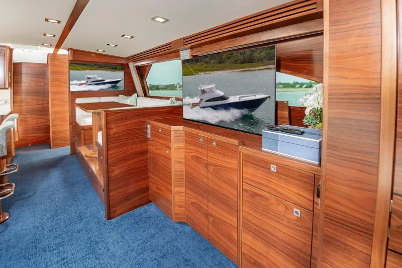 Slide: The Image of Luxurious interior of 2024 Viking 72 Convertible yacht with wood paneling and modern amenities. - 51