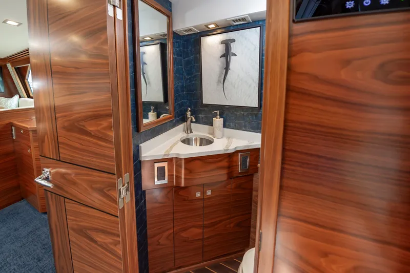 Slide: The Image of Luxurious bathroom interior of 2024 Viking 72 Convertible yacht with wood finish and modern fixtures. - 52