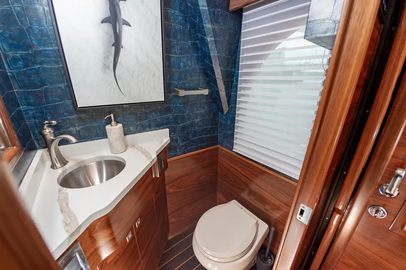 Slide: The Image of Luxurious bathroom in 2024 Viking 72 Convertible yacht with elegant wood and marble finishes. - 53