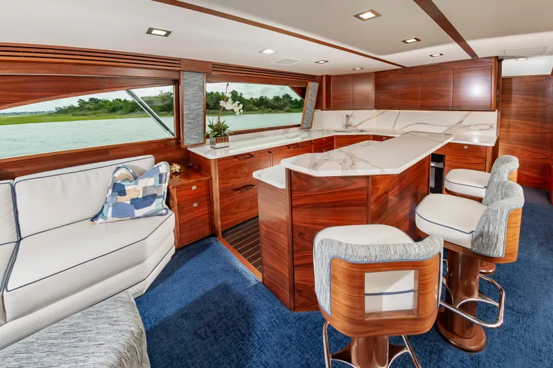 Slide: The Image of Luxurious interior of 2024 Viking 72 Convertible yacht with elegant wood finishes and modern seating. - 55