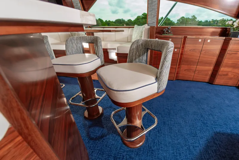 Slide: The Image of Luxurious interior of 2024 Viking 72 Convertible yacht with elegant seating and wooden finishes. - 56