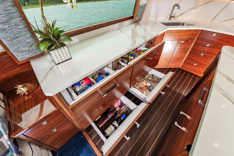 Slide: The Image of Luxurious kitchen interior of 2024 Viking 72 Convertible yacht with sleek cabinetry and modern design. - 58