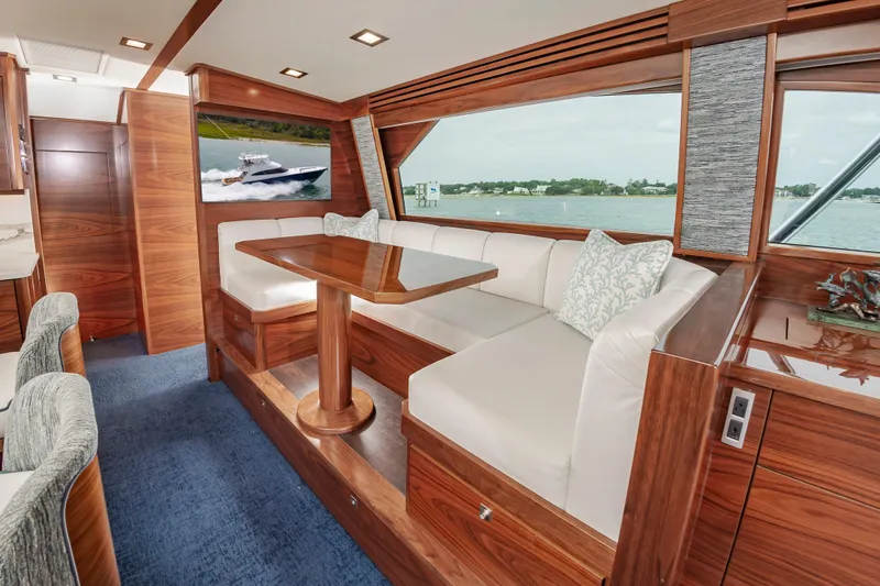 Slide: The Image of Luxurious interior of 2024 Viking 72 Convertible yacht with elegant wood finishes. - 62