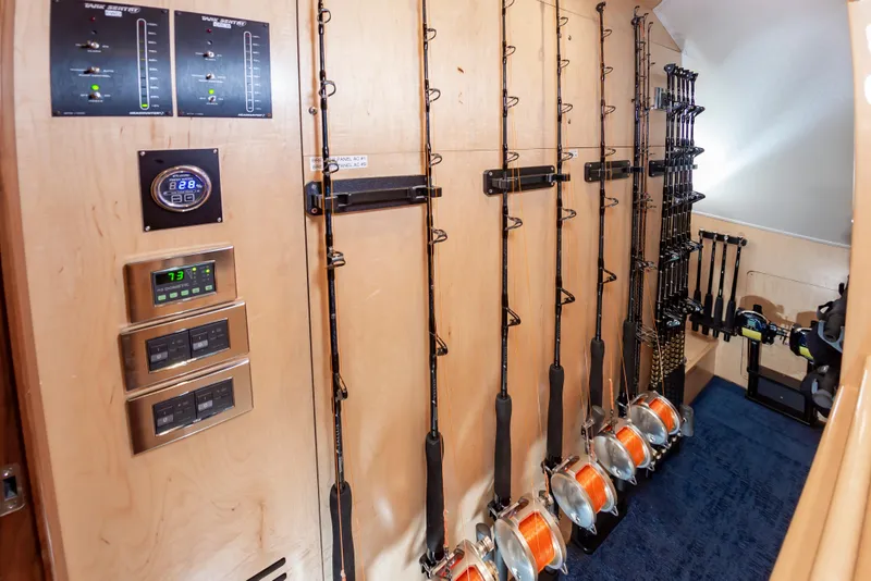 Slide: The Image of Fishing rod storage in 2024 Viking 72 Convertible yacht, featuring organized rods and control panels. - 65