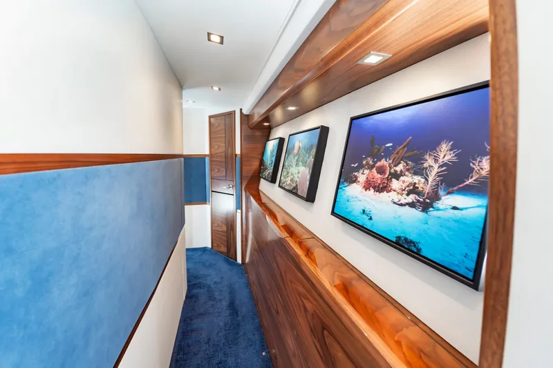 Slide: The Image of Luxurious hallway in 2024 Viking 72 Convertible yacht with ocean-themed artwork. - 66