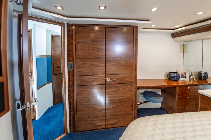 Slide: The Image of Luxurious interior of 2024 Viking 72 Convertible yacht with wood finishes and modern decor. - 69