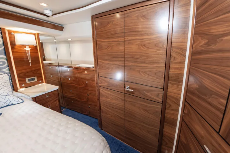 Slide: The Image of Luxurious wood-paneled interior of 2024 Viking 72 Convertible yacht bedroom. - 72