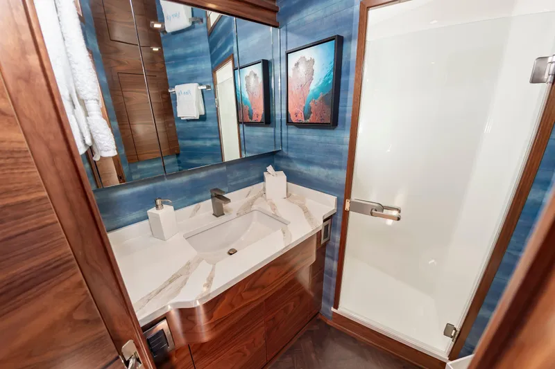 Slide: The Image of Luxurious bathroom in 2024 Viking 72 Convertible yacht with modern fixtures and elegant design. - 73