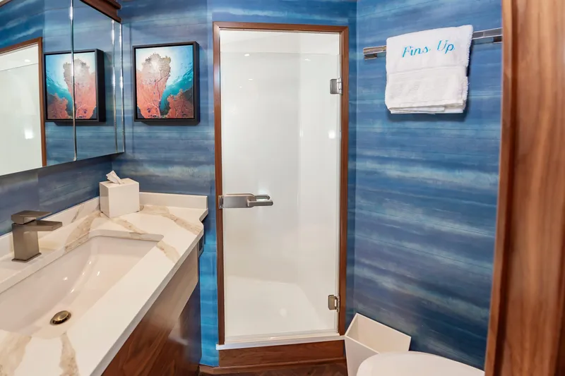 Slide: The Image of Luxurious bathroom in 2024 Viking 72 Convertible yacht with ocean-themed decor and modern fixtures. - 74