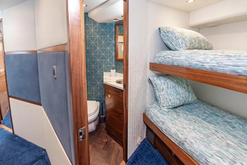 Slide: The Image of Interior of 2024 Viking 72 Convertible yacht with bunk beds and bathroom. - 78