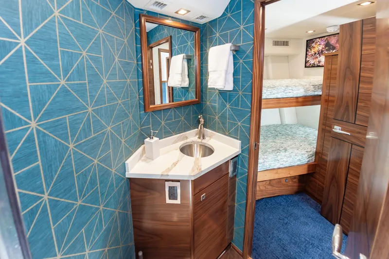 Slide: The Image of Luxurious bathroom and bunk beds in 2024 Viking 72 Convertible yacht interior. - 82
