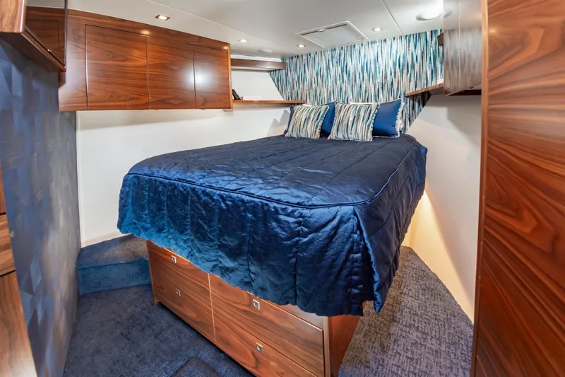 Slide: The Image of Luxurious bedroom interior of 2024 Viking 72 Convertible yacht with elegant wood finishes. - 83