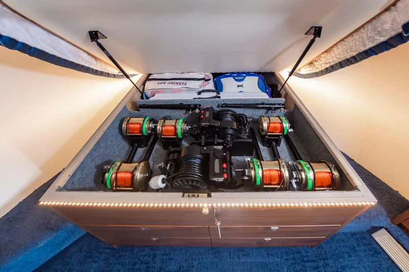 Slide: The Image of 2024 Viking 72 Convertible yacht storage with fishing reels and life jackets. - 85