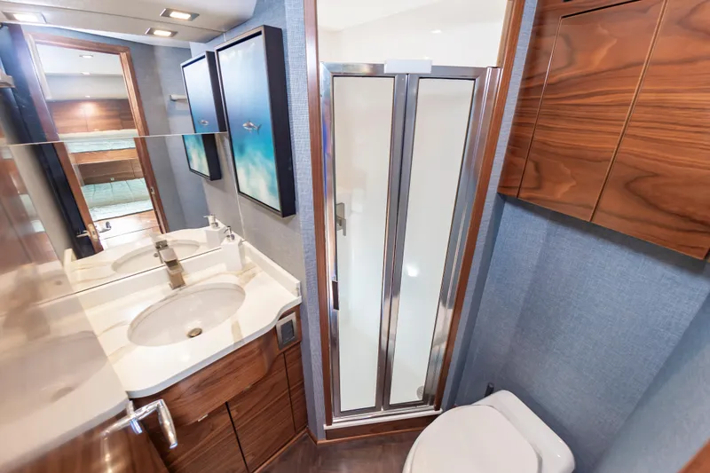 Slide: The Image of Luxurious bathroom in 2024 Viking 72 Convertible yacht with modern fixtures and elegant wood finishes. - 92