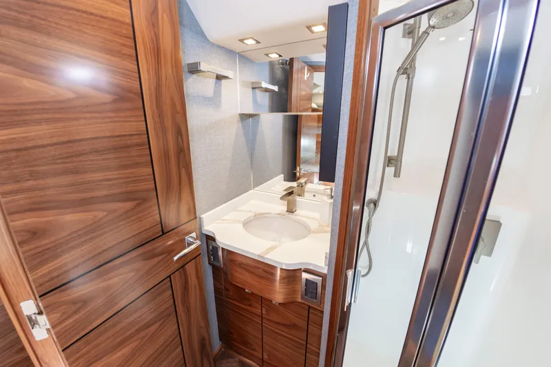 Slide: The Image of Luxurious bathroom in 2024 Viking 72 Convertible yacht with wood accents and modern fixtures. - 93
