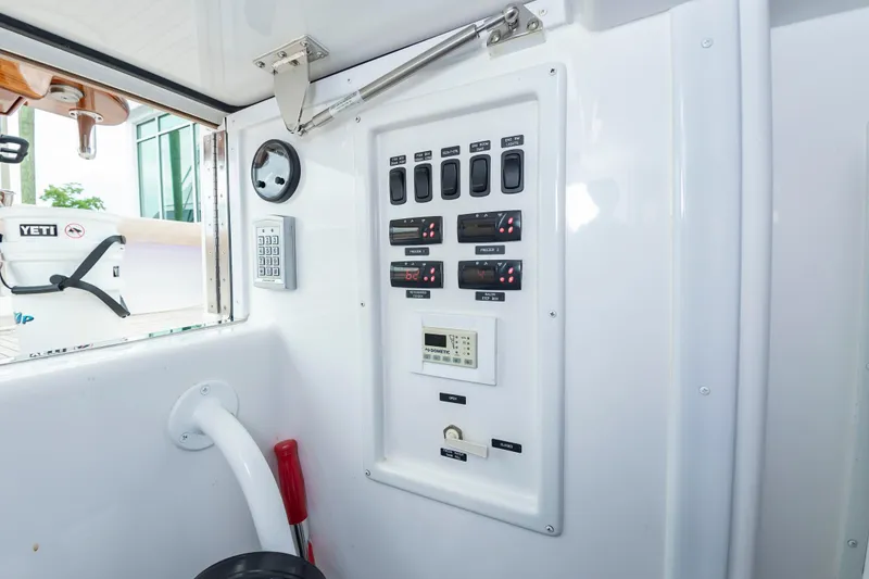 Slide: The Image of Control panel inside 2024 Viking 72 Convertible yacht, featuring switches and digital displays. - 95