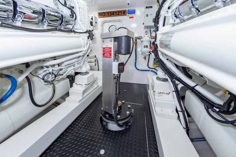 Slide: The Image of Engine room of 2024 Viking 72 Convertible yacht, showcasing advanced machinery and equipment. - 98