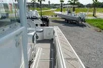 Slide: The Image of 2007 Fountain 38 CC Tournament Edition boat on a sunny day, parked on gravel. - 13