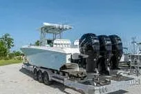 Slide: The Image of 2007 Fountain 38 CC Tournament Edition boat on trailer with triple outboard engines. - 7