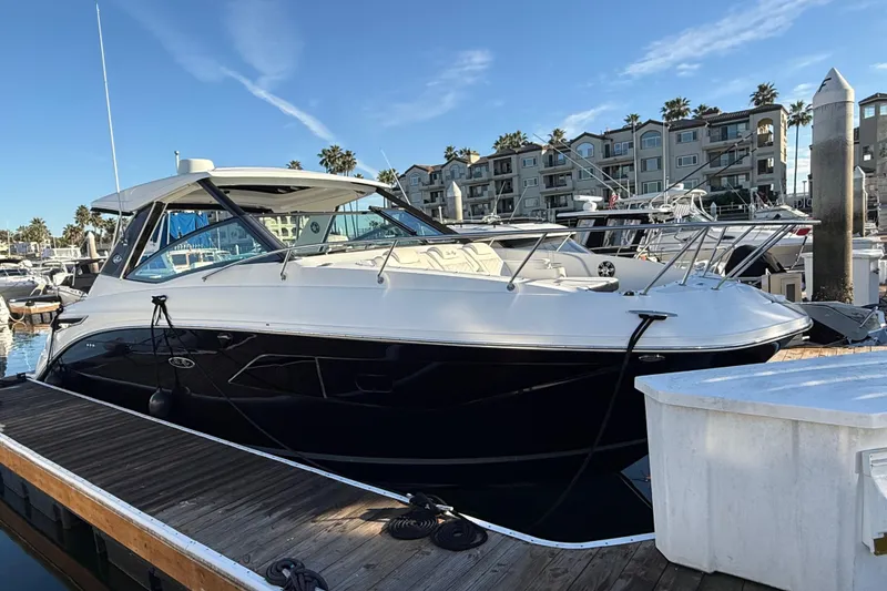 The Image of 2019 Sea Ray 320 Sundancer docked at marina with clear blue sky. - 0