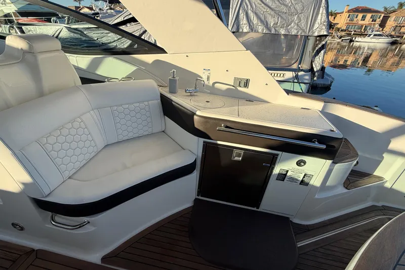 Slide: The Image of Luxurious interior of 2019 Sea Ray 320 Sundancer yacht with seating and kitchenette. - 11