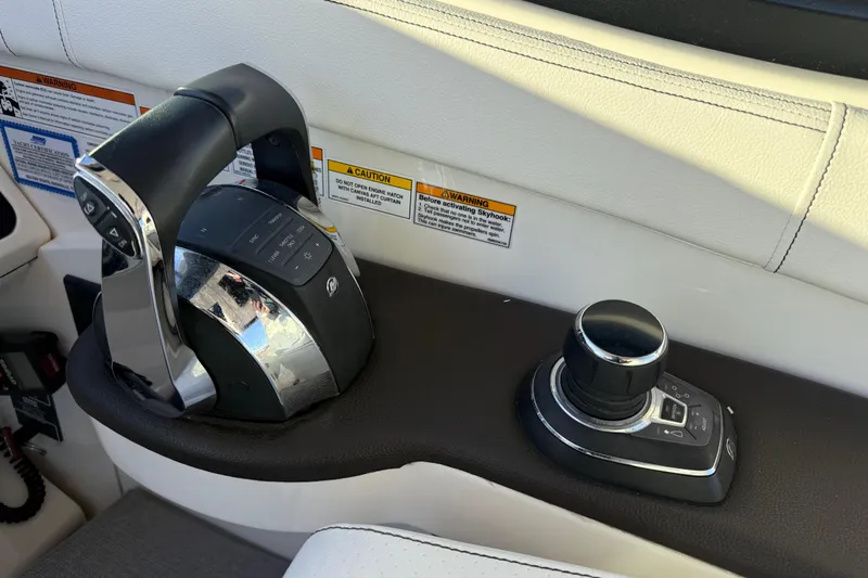 Slide: The Image of Control panel of a 2019 Sea Ray 320 Sundancer boat with throttle and joystick. - 15