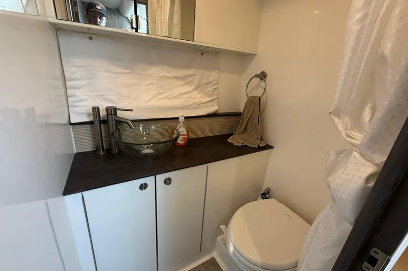 Slide: The Image of Modern bathroom in 2019 Sea Ray 320 Sundancer yacht with glass sink and toilet. - 20