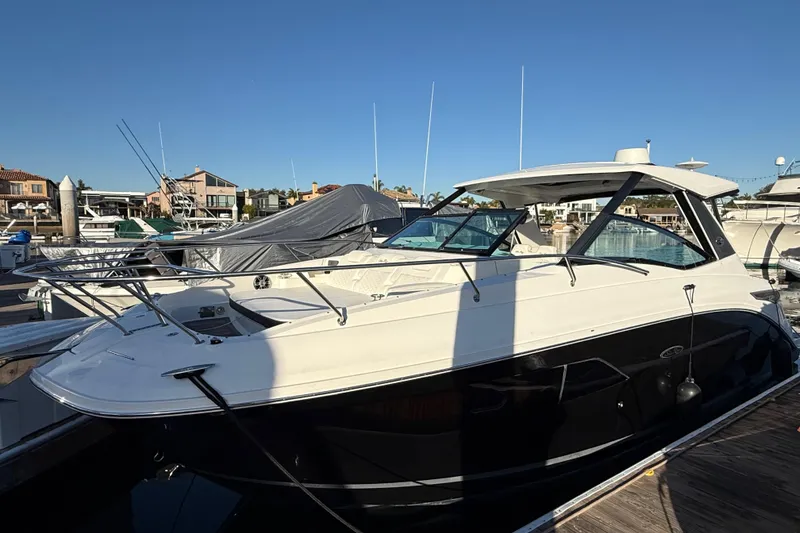 Slide: The Image of 2019 Sea Ray 320 Sundancer docked at a marina under clear blue skies. - 3