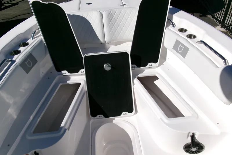 Slide: The Image of 2026 Sea Fox 248 Commander boat interior with open storage compartments and cup holders. - 10