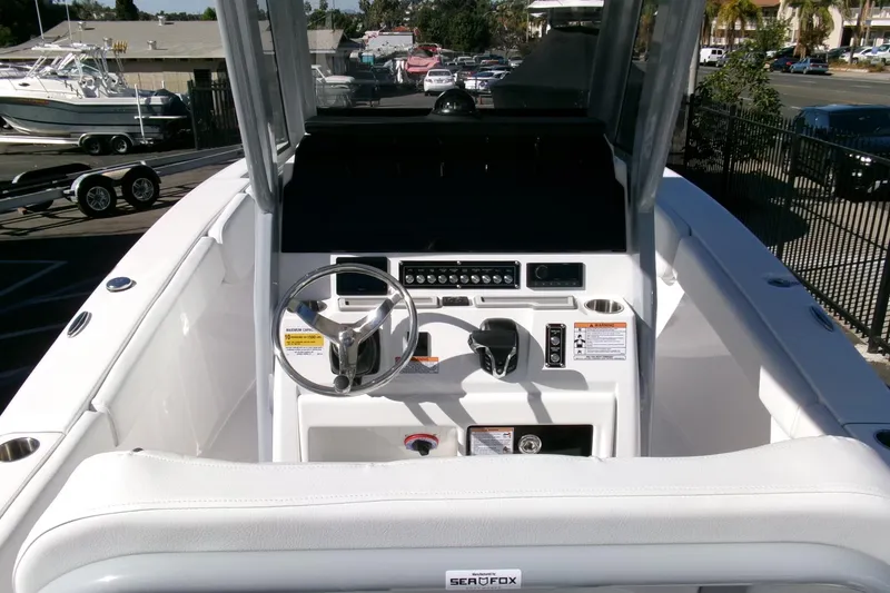 Slide: The Image of 2026 Sea Fox 248 Commander boat cockpit with steering wheel and control panel. - 17