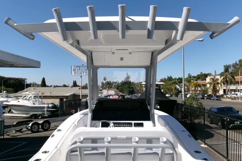 Slide: The Image of 2026 Sea Fox 248 Commander boat with T-top and rod holders, parked at a marina. - 22