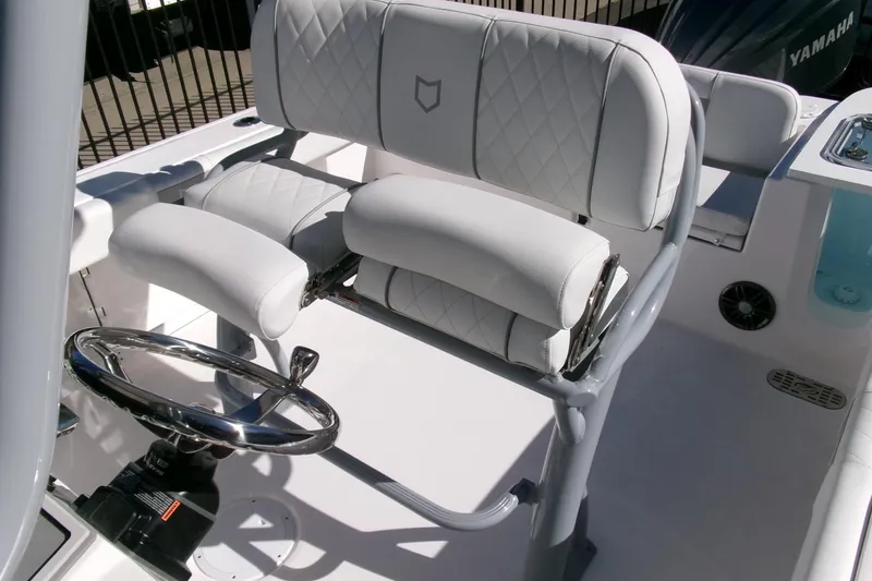 Slide: The Image of 2026 Sea Fox 248 Commander boat interior with white cushioned seating and steering wheel. - 23