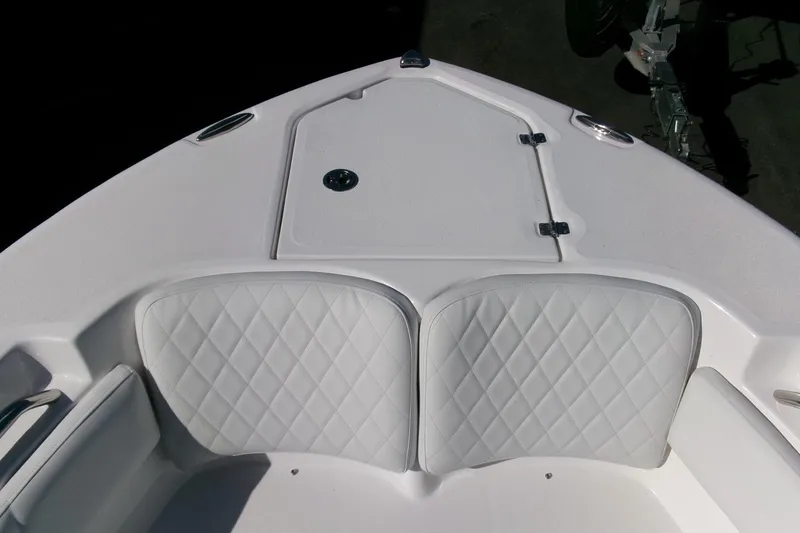 Slide: The Image of 2026 Sea Fox 248 Commander boat bow with white cushioned seating and storage hatch. - 4